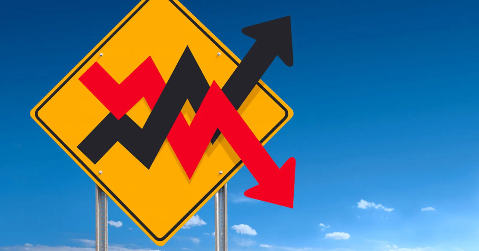 Yellow road sign with red and black arrows indicating upward and downward trends.